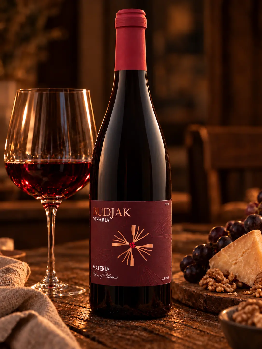 Materia with a glass of red wine, cheese, grapes and walnuts